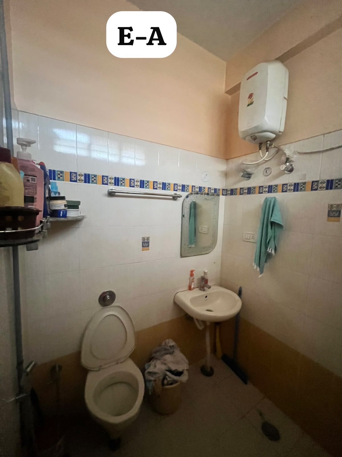 Second bathroom — worn sanitaryware and mismatched dado band