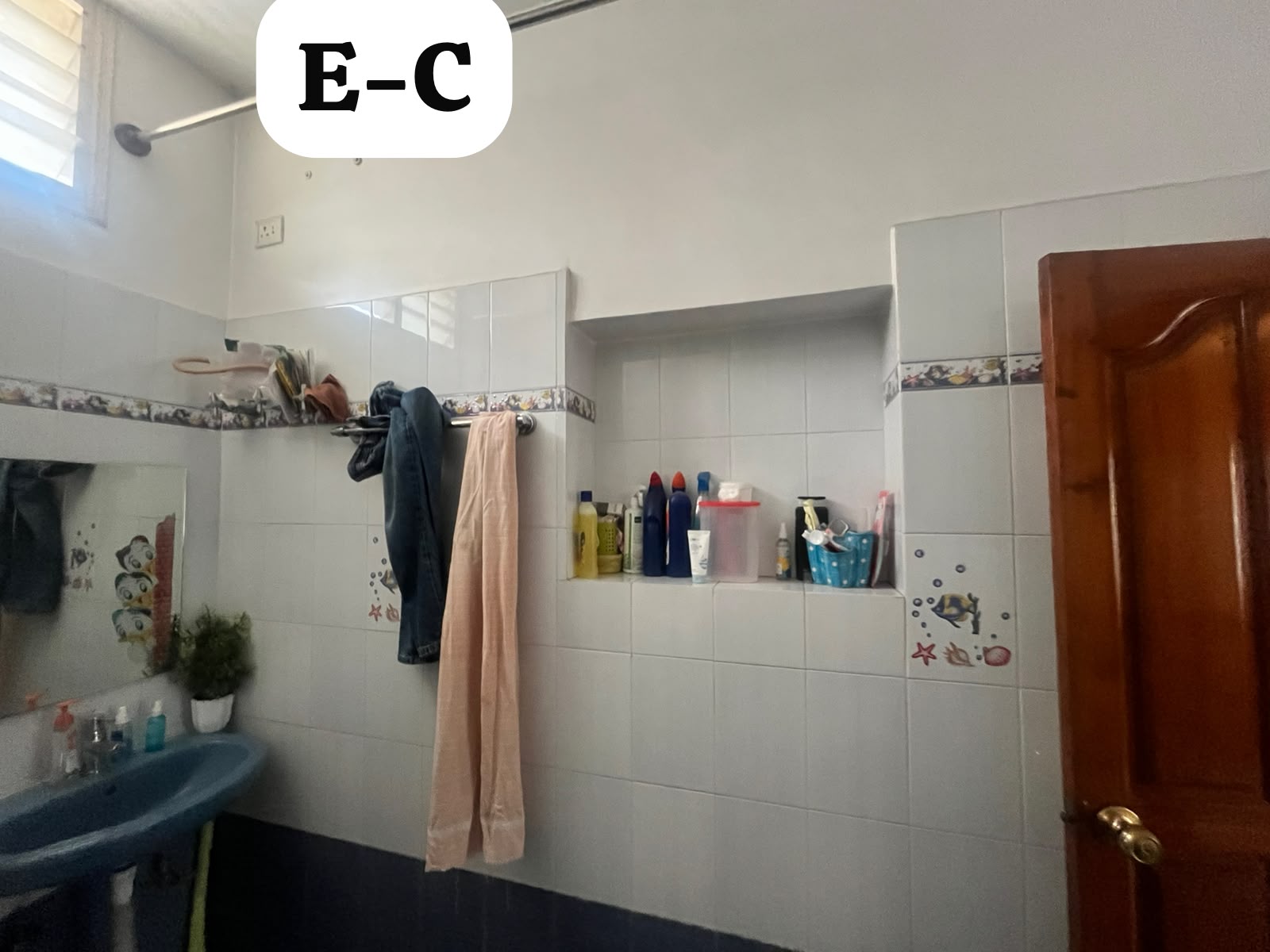 Old storage niche and towel rail wall before demolition