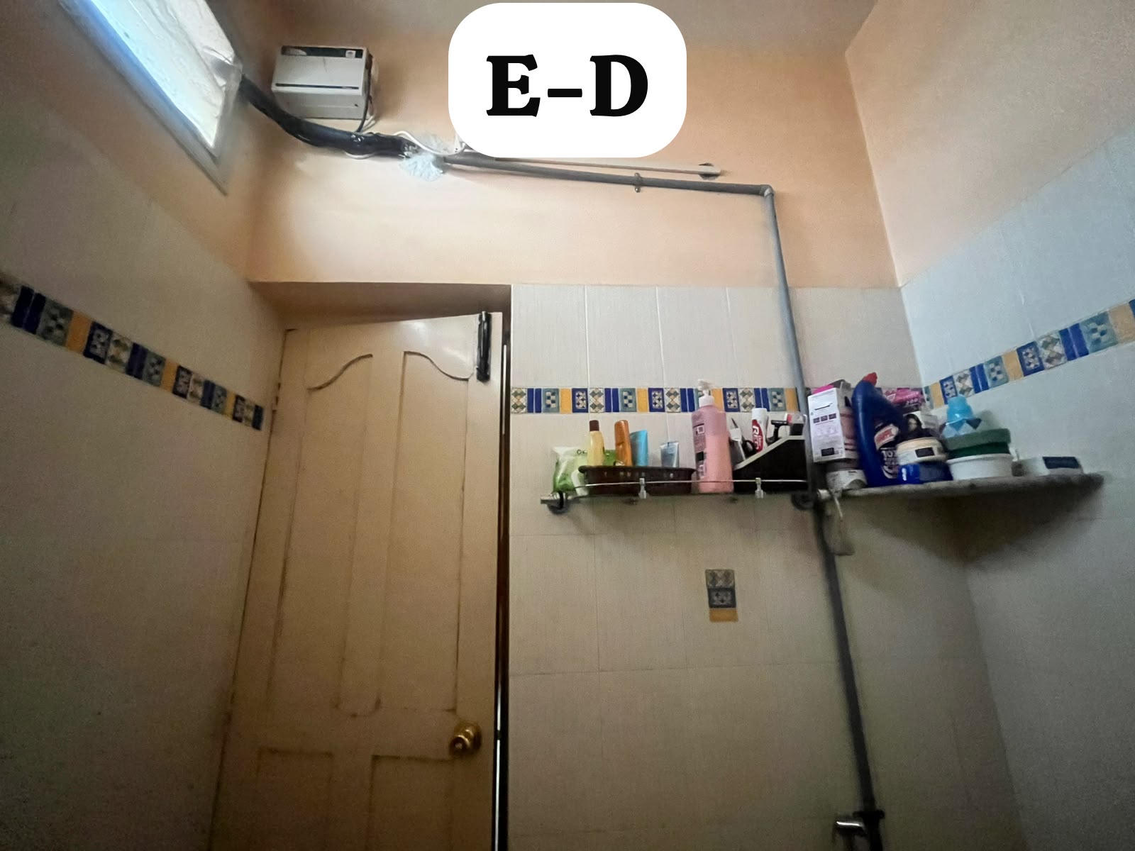 Exposed geyser line and old shelving in the second bathroom