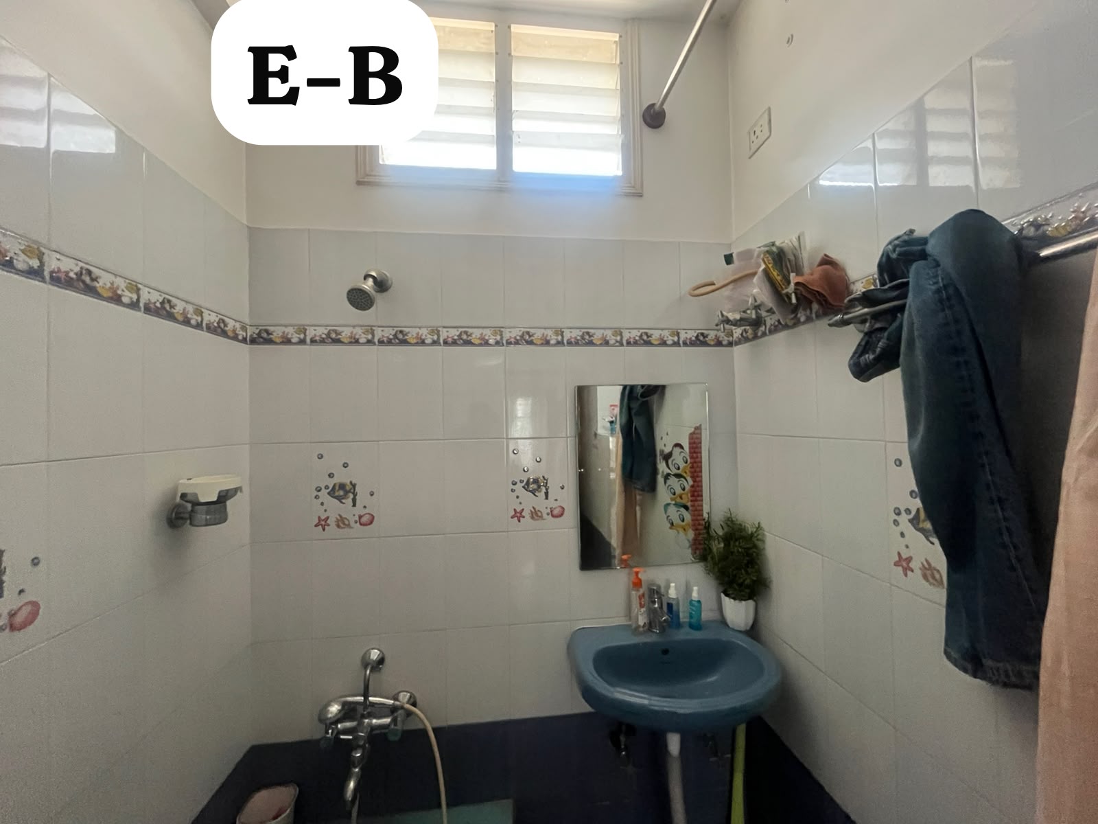 Blue wash basin, wall mirror and surface-mounted plumbing