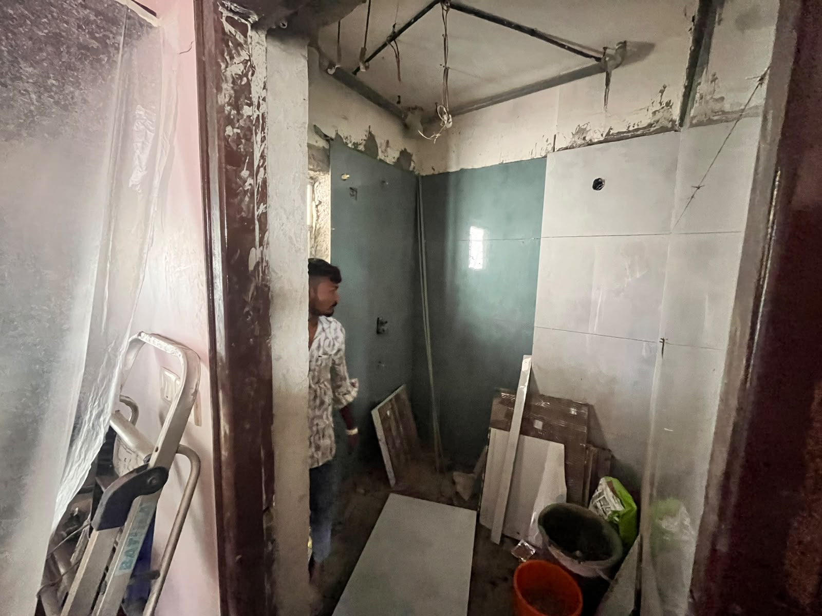 Walls stripped back and first course of new tiles being trialled